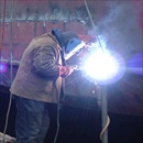 Welder Repairing Hole In Side Of Ship